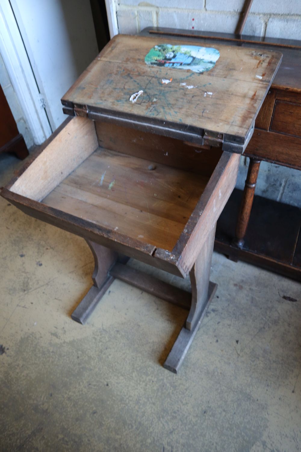 An early 20th century oak school desk, width 56cm